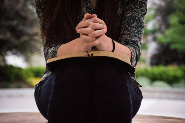 praying woman with bible Stock Photo