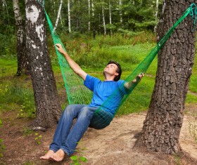 A man sitting on hammock Stock Photo