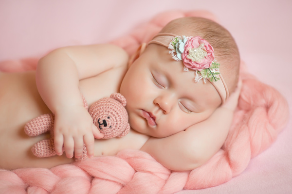 Baby holding knitted bear sleeping Stock Photo 02
