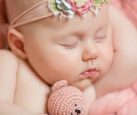 Baby holding knitted bear sleeping Stock Photo 03