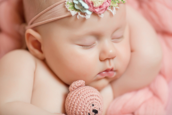 Baby holding knitted bear sleeping Stock Photo 03