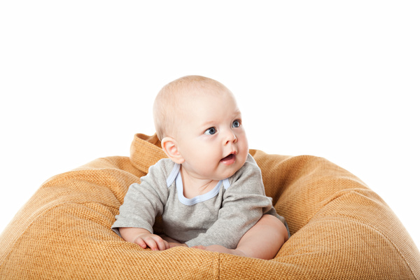 Baby sitting in inflatable chair Stock Photo