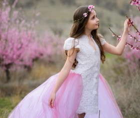 Beautiful little girl posing with flowers Stock Photo