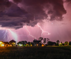 Black clouds and lightning over the village Stock Photo