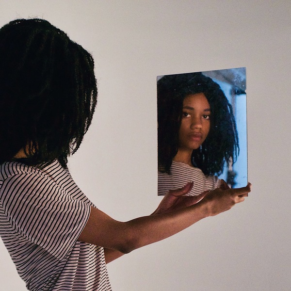 Black young girl posing via mirror Stock Photo