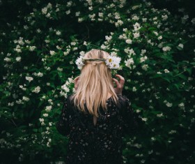 Blonde girl posing with flower wreath on head Stock Photo
