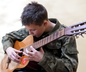 Boy playing guitar Stock Photo