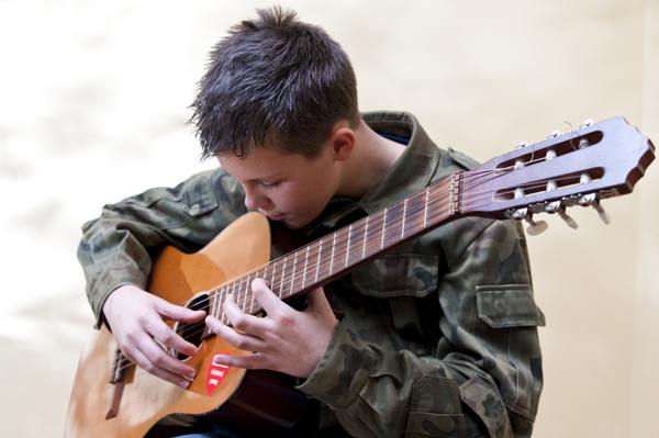 Boy playing guitar Stock Photo