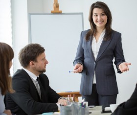Business woman explaining at conference Stock Photo