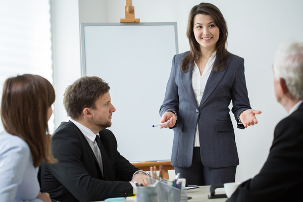 Business woman explaining at conference Stock Photo