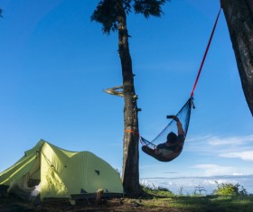 Camping tents and selfie people lying on the hammock Stock Photo
