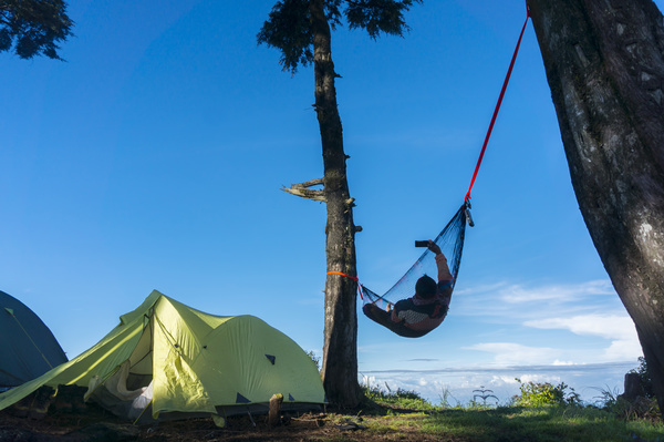 Camping tents and selfie people lying on the hammock Stock Photo