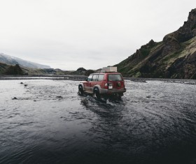 Car driving on wet water pool Stock Photo