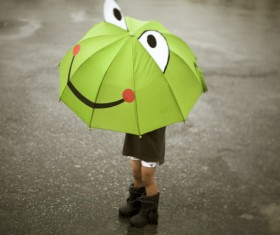 Child playing cartoon frog umbrella Stock Photo