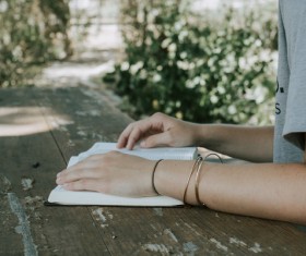 Closeup girl hands on wooden table Stock Photo