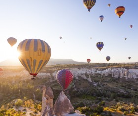 Colorful balloons flying towards the sun Stock Photo