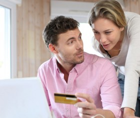 Couple using laptop for online payment Stock Photo 01