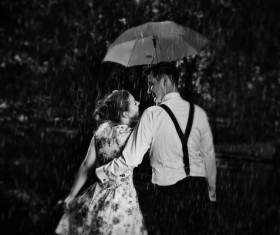 Couple walking with umbrella Stock Photo