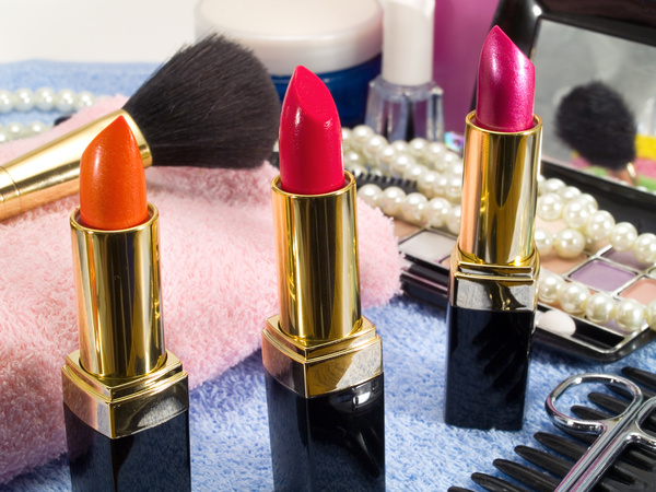 Different colors of lipstick and powder box Stock Photo