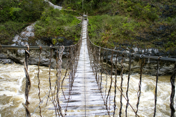 Dilapidated suspension bridge Stock Photo