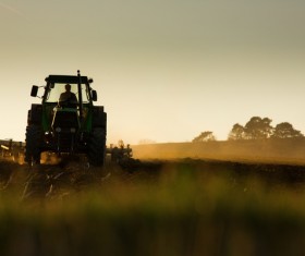 Driving tractor turn up the soil Stock Photo 02