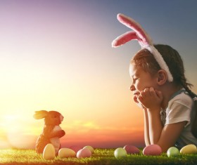 Easter egg and little girl wearing rabbit ears Stock Photo