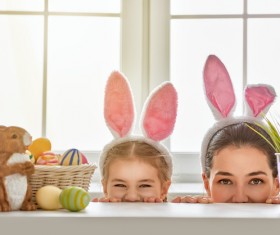 Easter eggs and mother and daughter wearing rabbit ears Stock Photo