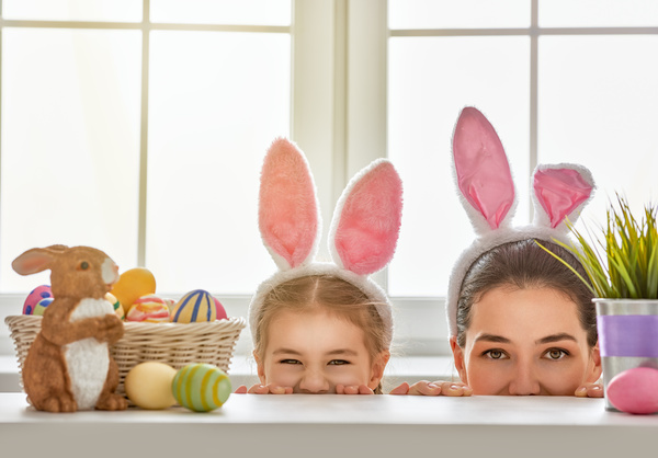 Easter eggs and mother and daughter wearing rabbit ears Stock Photo
