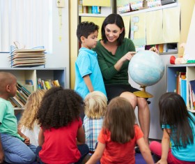 Elementary pupils listen to teacher lectures Stock Photo