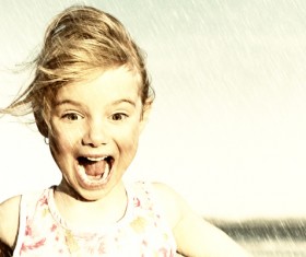 Excited little girl in the rain Stock Photo