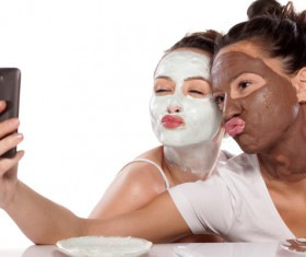 Girl doing facial mask selfie Stock Photo