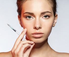 Girl holding botox injection Stock Photo