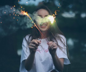 Girl holding fireworks Stock Photo