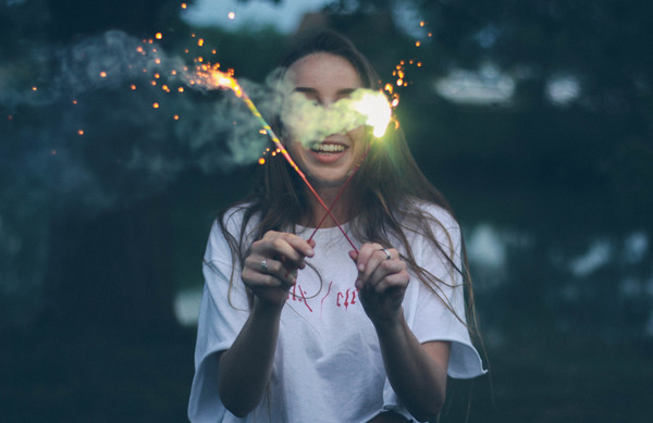 Girl holding fireworks Stock Photo