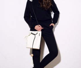 Girl in black costume holding white waist bag Stock Photo