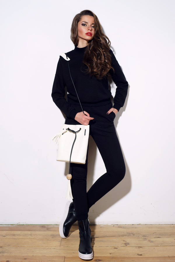 Girl in black costume holding white waist bag Stock Photo