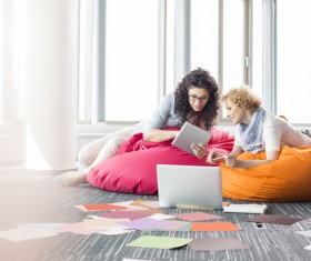 Girl playing Tablet PC in inflatable chair Stock Photo 02