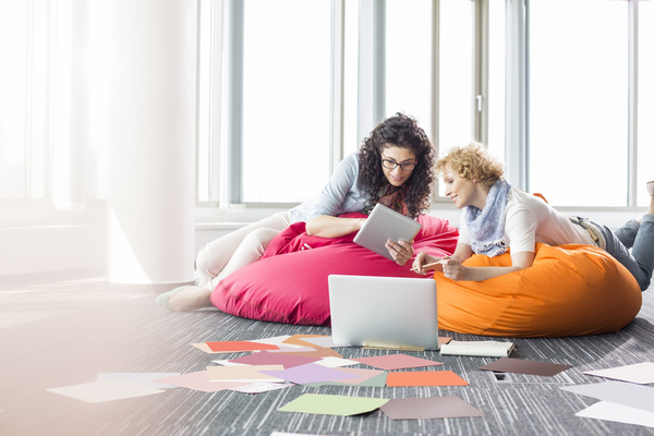 Girl playing Tablet PC in inflatable chair Stock Photo 02