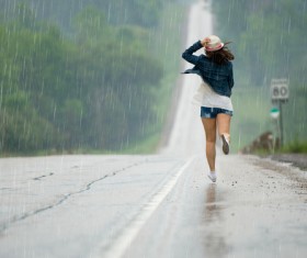 Girl running in the rain Stock Photo