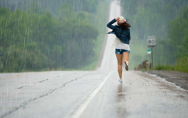 Girl running in the rain Stock Photo