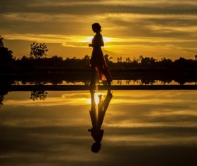 Girl walking in the sunset Stock Photo