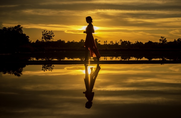 Girl walking in the sunset Stock Photo
