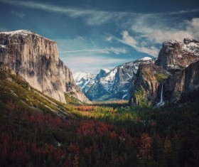 Green trees on awesome snowy rocky mountain landscape Stock Photo