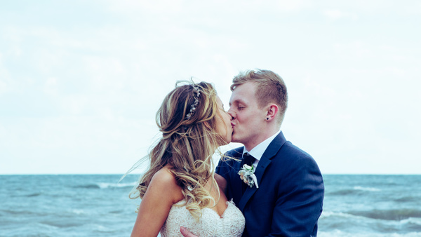 Happy marriage couple kissing on beach Stock Photo