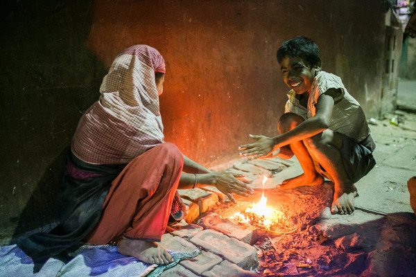 Homeless people warm up by the fire Stock Photo