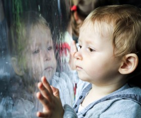Little boy looking out the window Stock Photo