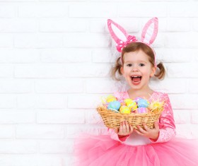 Little girl holding a basket with Easter eggs Stock Photo