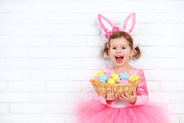 Little girl holding a basket with Easter eggs Stock Photo