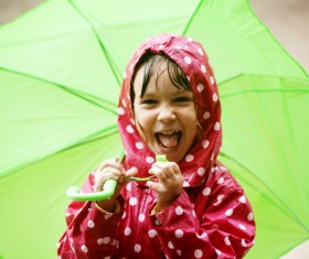 Little girl holding an umbrella on a rainy day Stock Photo