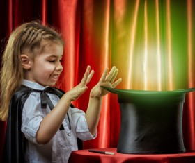 Little girl playing magic Stock Photo